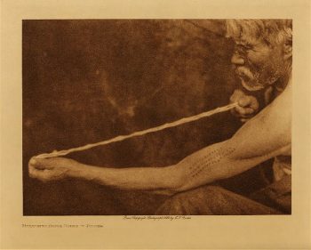 Measuring shell money (Tolowa) 1923