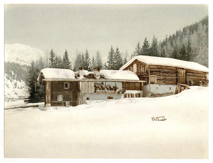 Winter scene with log structure and sled