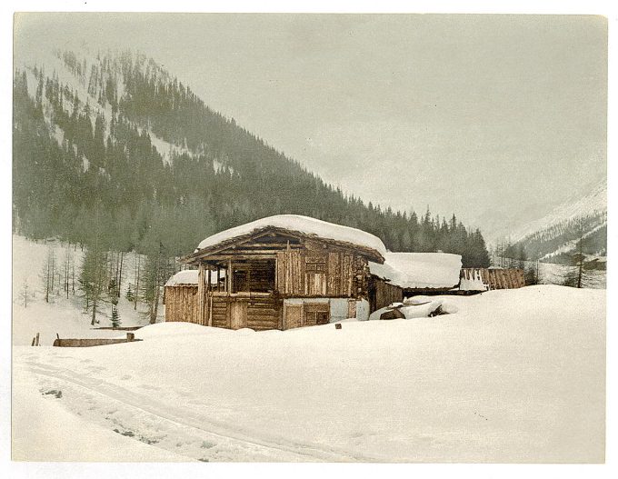 Winter scene with log structure covered in snow